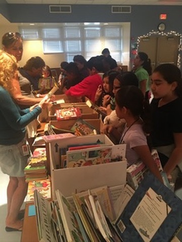 Sorting donated books with volunteers