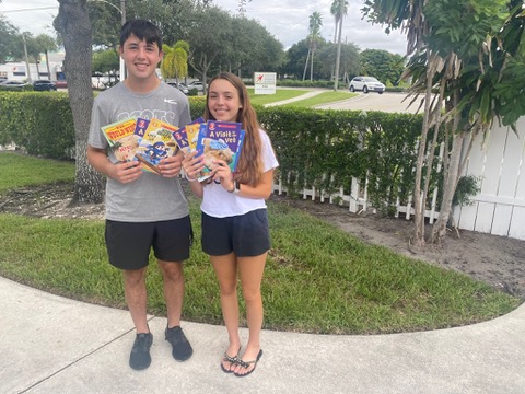 Volunteers with a stack of donated books